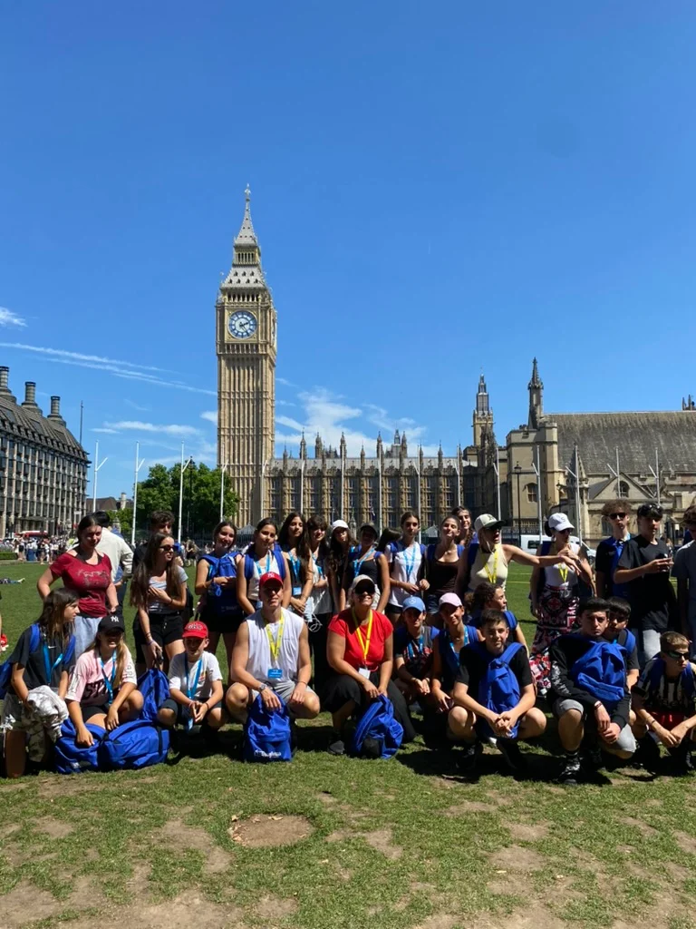Group of students gathered near Big Ben and the Palace of Westminster during an educational trip in London.