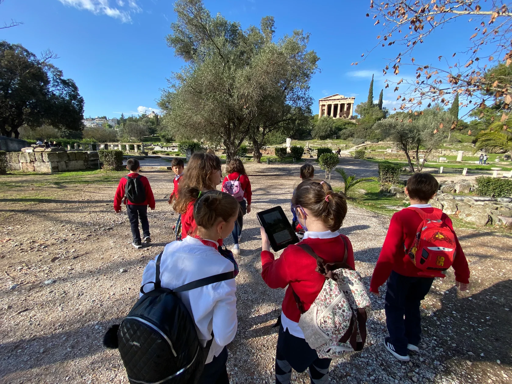 Students participating in an interactive learning activity during a school field trip at a historic site.